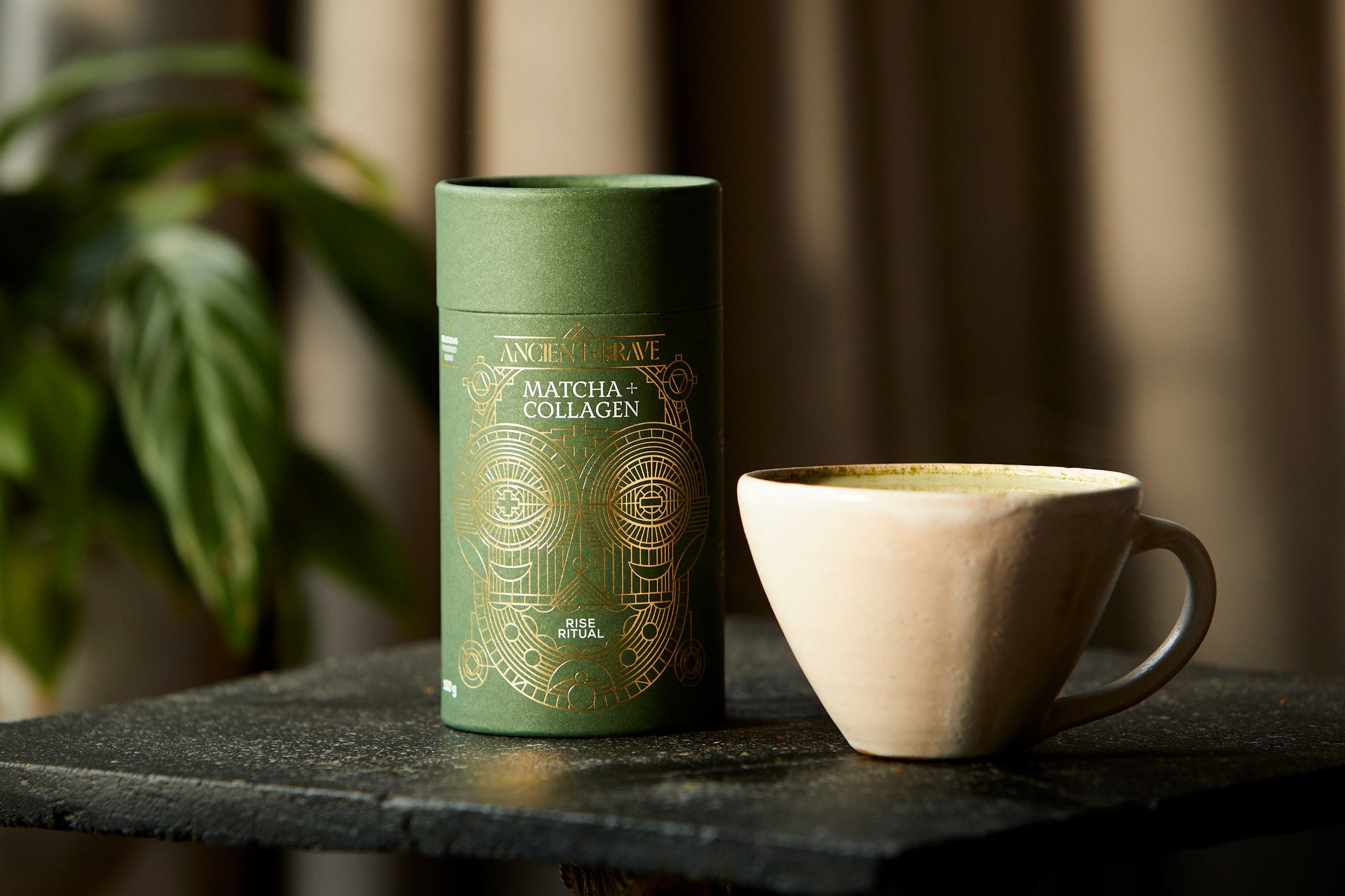 Matcha + Collagen next to a ceramic mug.