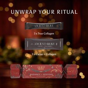 An Ancient + Brave Radiance + Restore Cracker sits below three True Collagen sachets and three Cacao + Collagen sachets against a blurred background of warm lights.
