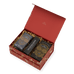 An open red gift box containing a Davina Ritual Gift Set, with two boxes of dietary supplements and a long, narrow container labeled The Ritual Scoop nestled in gold paper filler.