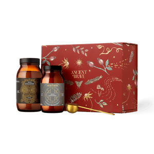 The Ancient + Brave Davina Ritual Gift Set includes two amber glass jars of collagen peptides and creatine, a gold measuring scoop, and a decorative red gift box.