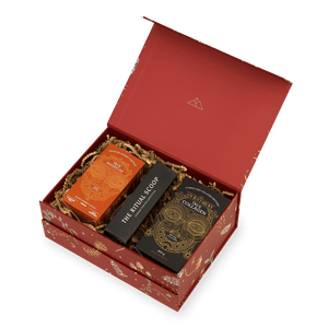 An open red Ancient + Brave Rest Gift Set box containing a restorative sleep tonic, a collagen peptides canister, and a long black box labeled The Ritual Scoop, all nestled in shredded paper.