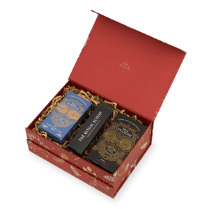 An open red Ancient + Brave Rise Gift Set containing a wellbeing set of electrolyte powder, collagen peptides, and a thin black box labeled The Ritual Scoop.