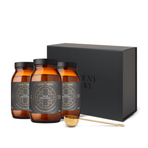 3 amber glass jars of True Creatine+ with a black gift box in the background, and a gold ritual scoop from Ancient and Brave