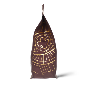 Side of Ancient + Brave's protein packaging with gold geometric patterns on a white background