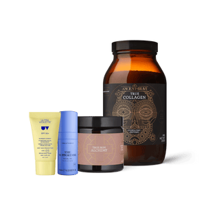 The Skin Essentials Kit featuring a yellow tube of daily SPF protection sunscreen, a blue bottle of facial oil, a small jar of skin cream, and a large amber jar of ingestible skincare collagen powder.