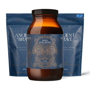 An amber glass jar of Ancient + Brave Wild Collagen centered in front of two blue resealable pouches on a black background.