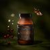 True Collagen Ritual Gift Set featuring an amber glass jar of hydrolysed bovine collagen powder with a geometric label, a small branch of red berries, gold star accents, and a butterfly.